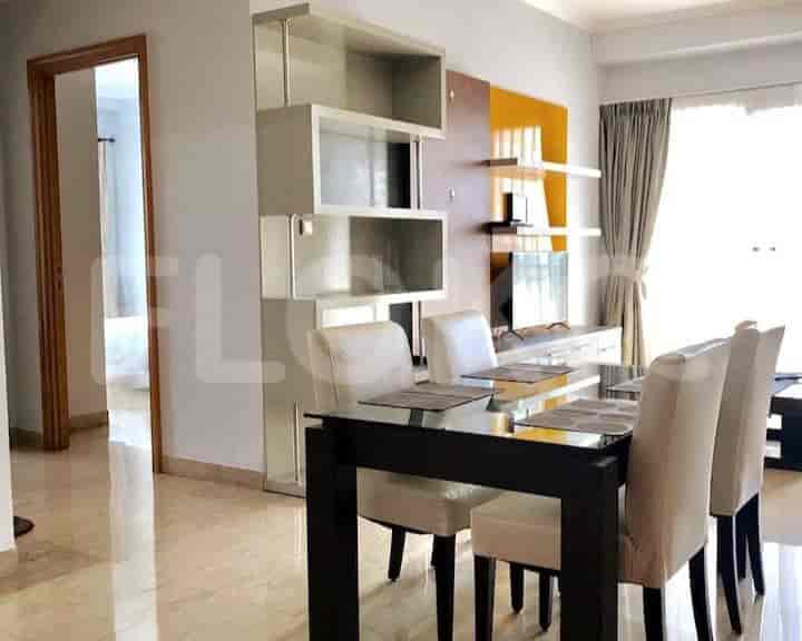 Contemporary dining space with glass-top table and stylish chairs.