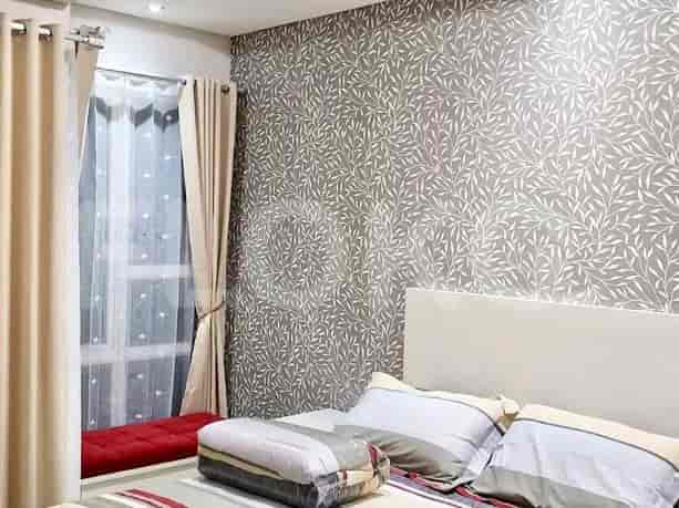 A bedroom with a bed and curtains