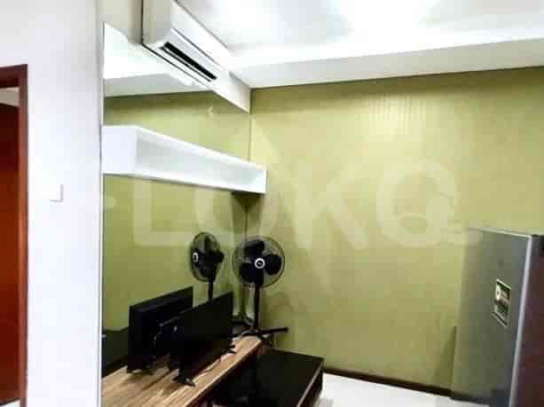 A living room with a tv and fans