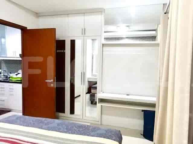 A bedroom with a bed and a closet