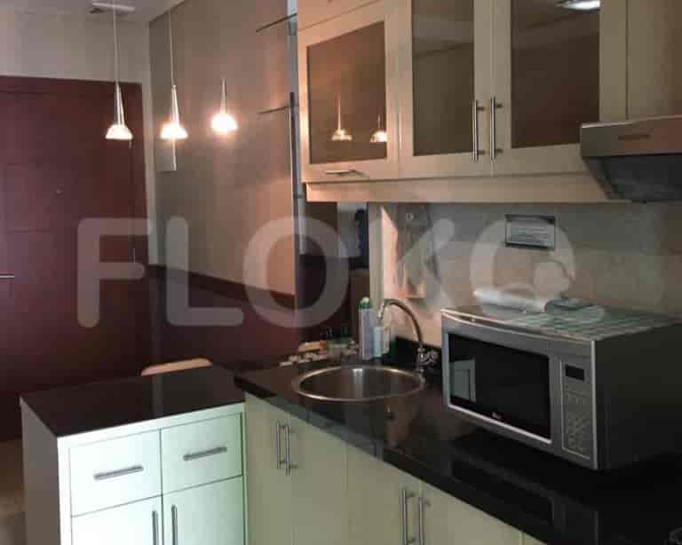 Kitchen area with overhead cabinets and appliances.