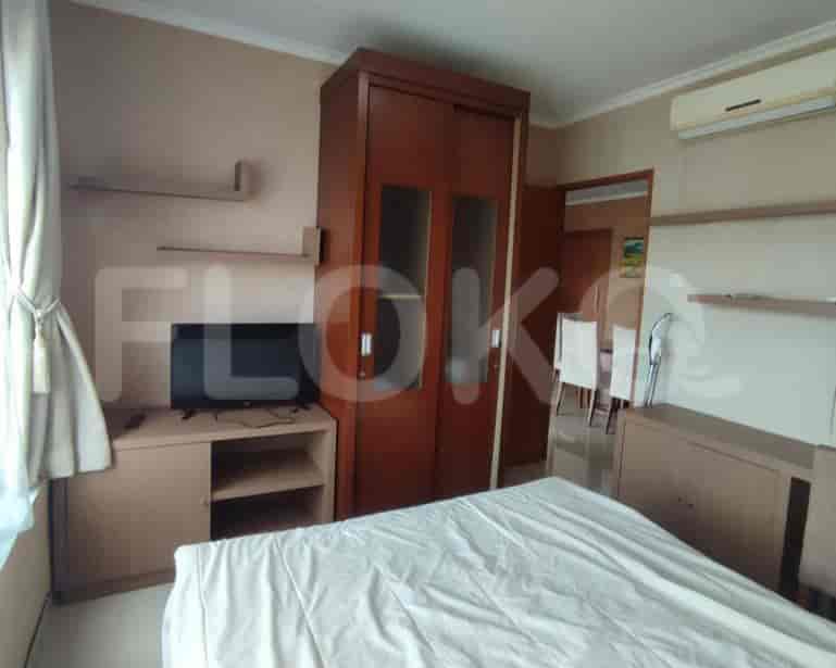 Kamar tidur dengan tempat tidur, TV, dan lemari pakaian.
