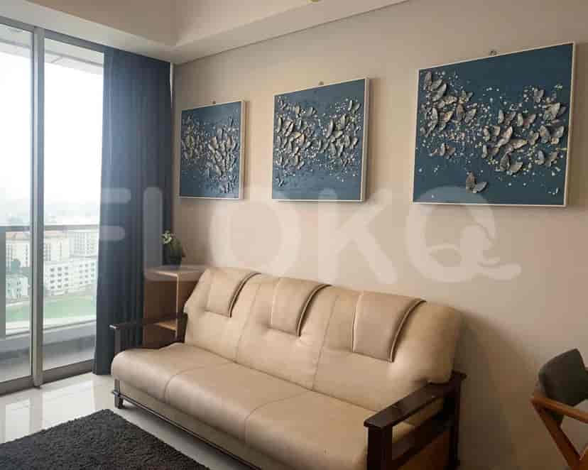 Living room with a sofa, art, and a window.