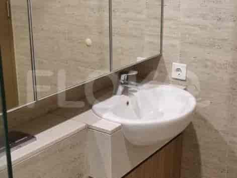 A clean and modern bathroom with a sink and mirror.