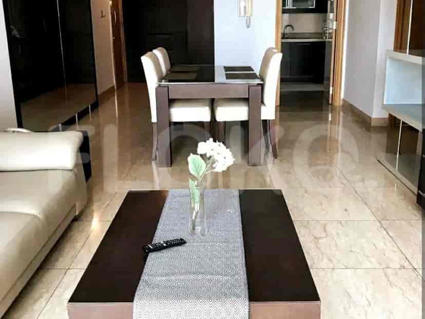 Open-plan living and dining area with a dining table and sofa.