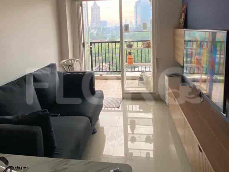 Modern living room with a dark grey sofa and access to a balcony.