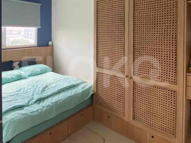 Bedroom with a queen bed and a wooden closet.