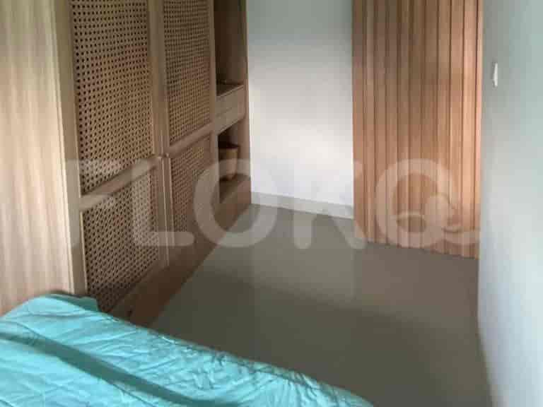 Bedroom with a queen bed and wooden closet.
