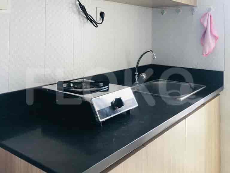 Close-up of a kitchen countertop with a gas stove and a sink.