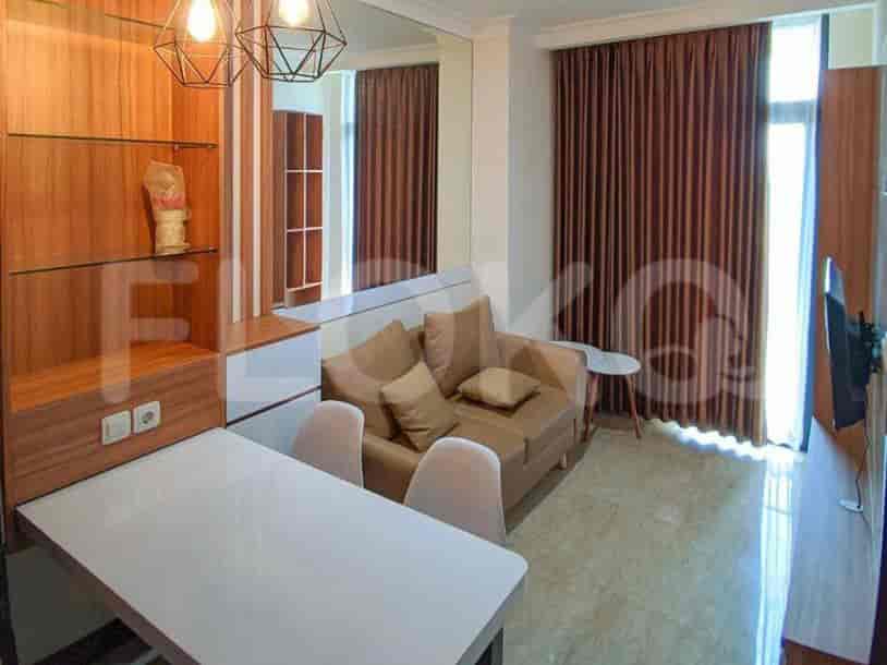 A cozy bedroom featuring a double bed, a dressing table, and a large mirror.