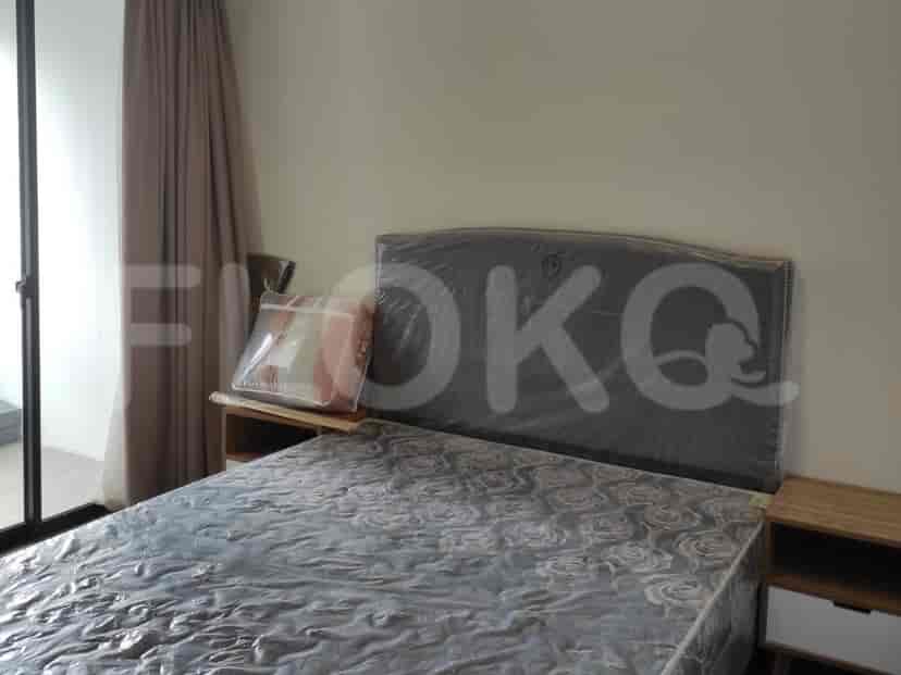 A bedroom featuring a bed and curtain.