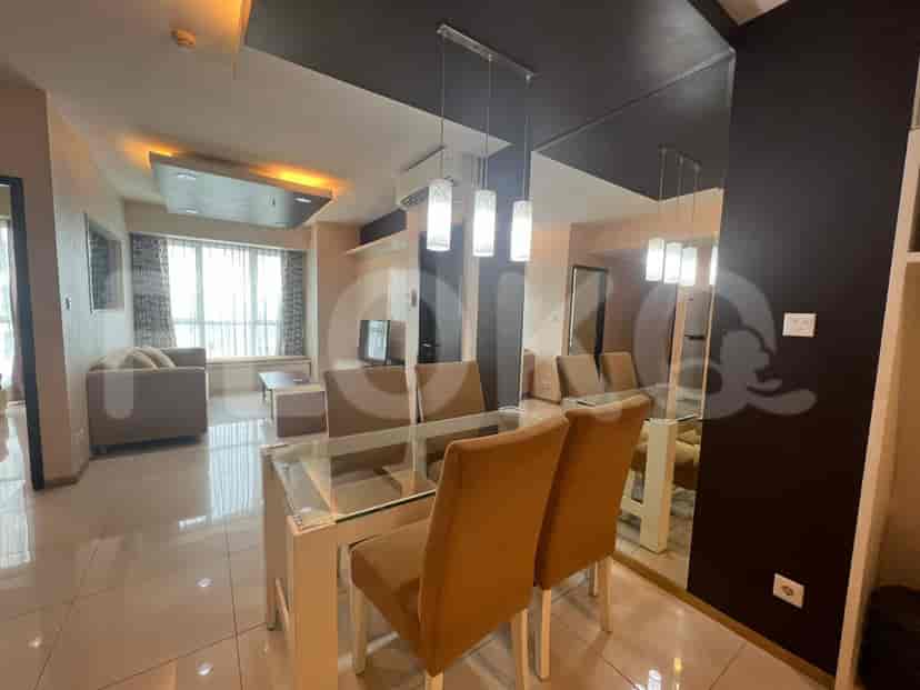 Elegant dining area with a glass-top table and upholstered chairs.