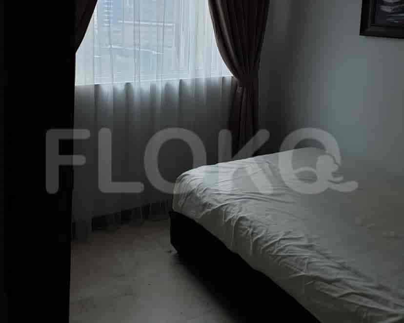 Bedroom with a bed, curtains, and window.