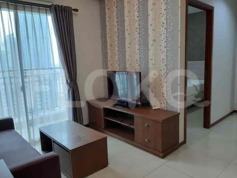 Living room with TV, sofa, and coffee table.