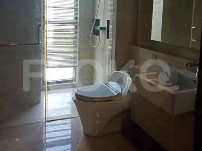 Bathroom with a toilet, sink, and shower.