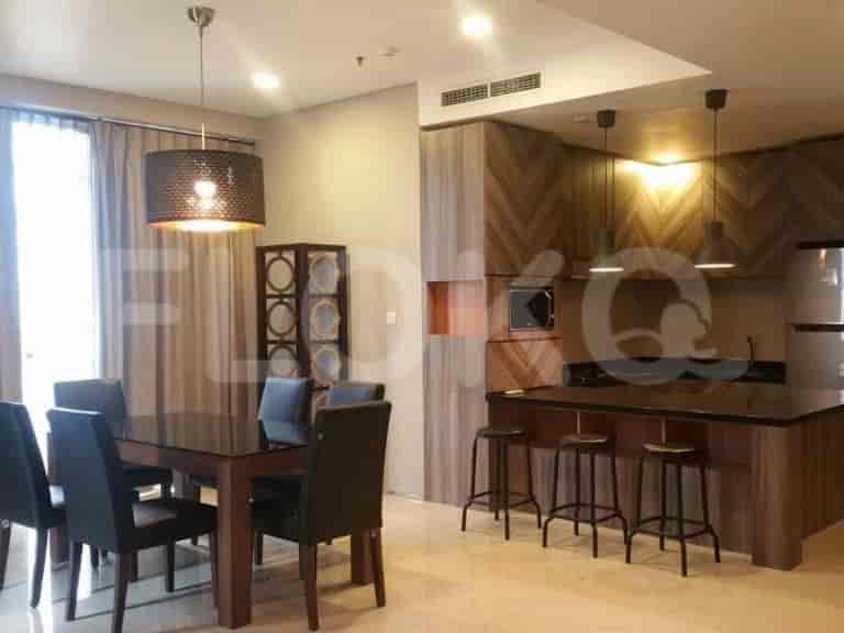 Living room with a dining area and kitchen in the background.
