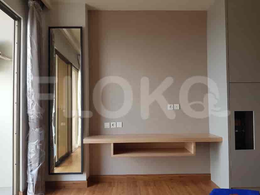 Modern bedroom with a floating desk, full-length mirror, and wooden accents.