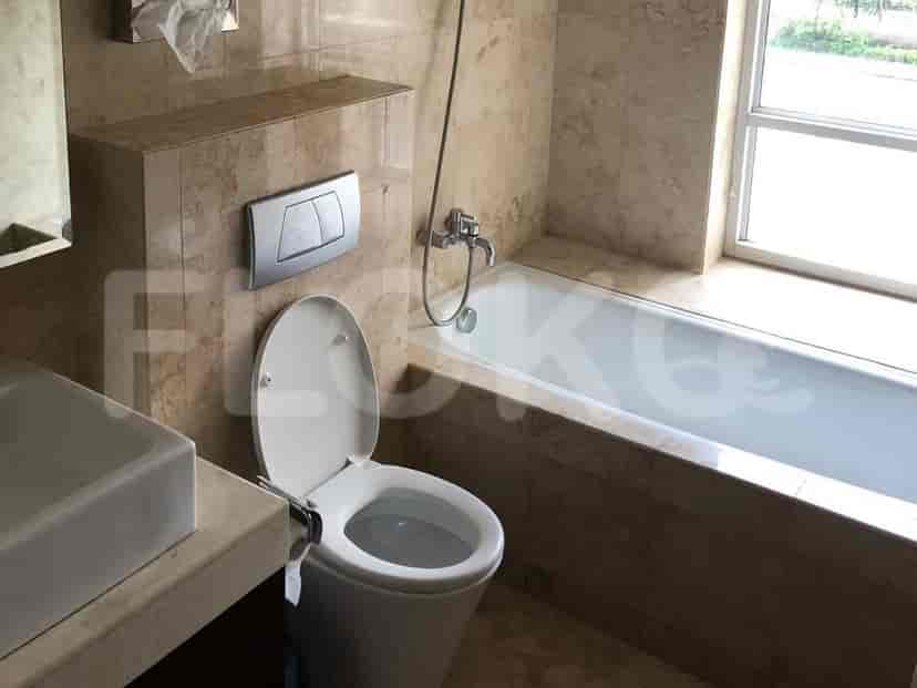 A spacious bathroom with a bathtub, toilet, and sink.