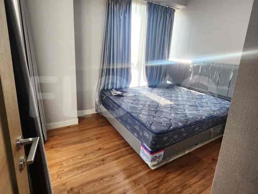 Bedroom with a large bed and natural light.