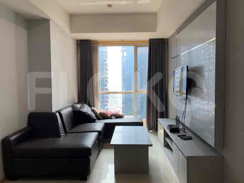 A modern living room with a grey L-shaped sofa, TV, and large window.