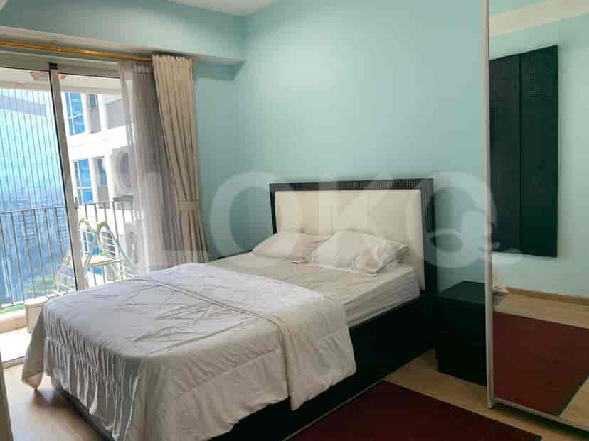 Bright bedroom with a double bed, balcony access, and modern decor.