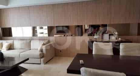 Combined living and dining area with a sofa, dining table, and decorative elements.