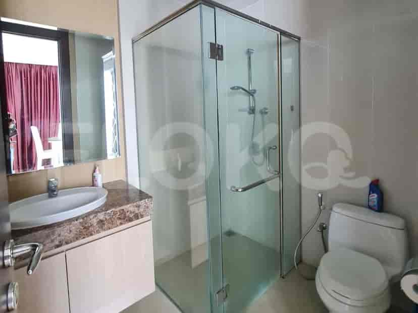 A bathroom featuring a glass shower enclosure and a washbasin.