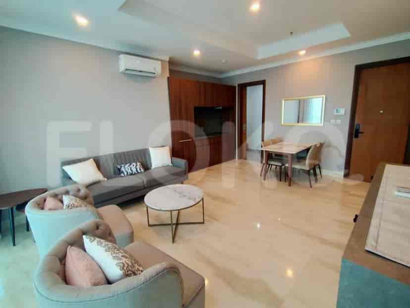 Spacious living room featuring a gray sofa, marble coffee table, and wooden cabinets.
