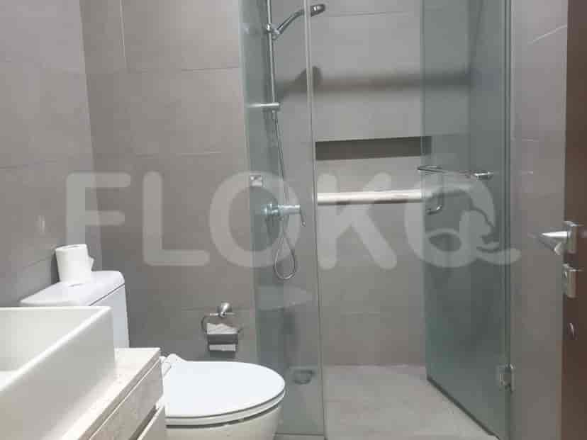 A bathroom with a shower, toilet, and sink.