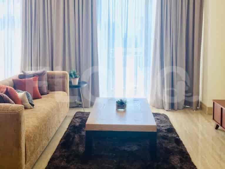 Living room with sofa, coffee table, and curtains.