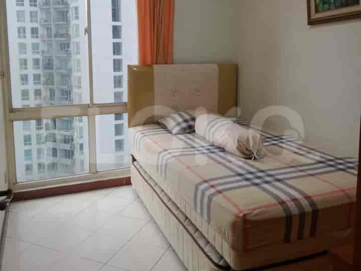 A small bedroom featuring a twin bed beside a large window.