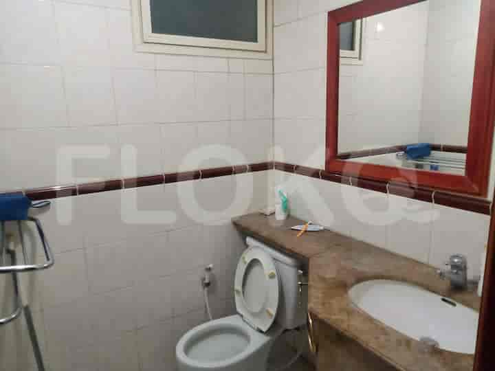 A neat bathroom equipped with a toilet, sink, and mirror.