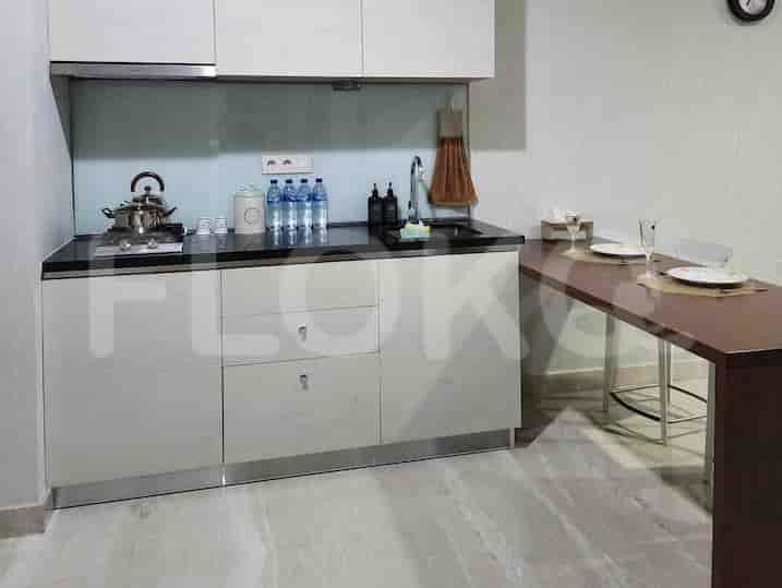 A modern kitchen setup with built-in appliances and a breakfast bar.