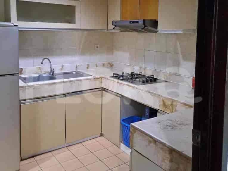 A closed kitchen featuring cabinets and appliances.