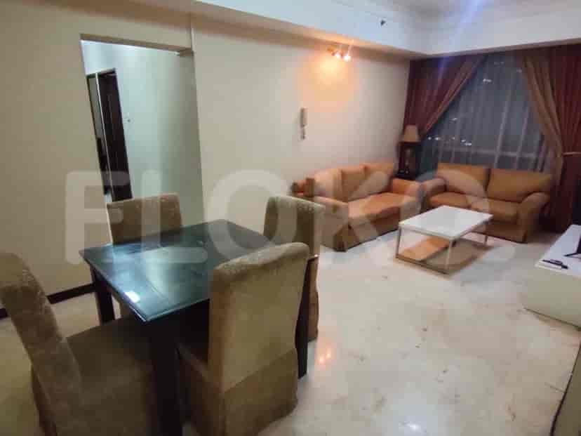 An overview of the dining area with a dining table and chairs, also a portion of the living room is visible.