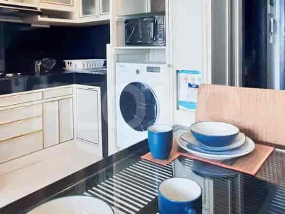 Kitchen and dining area with black countertop, appliances, and table setting.