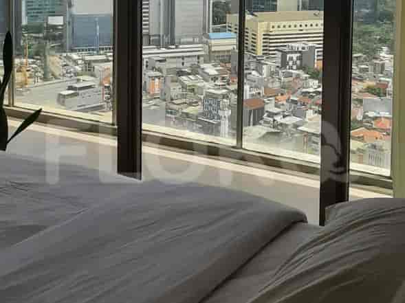 A bedroom with city view, bed, and modern aesthetic.