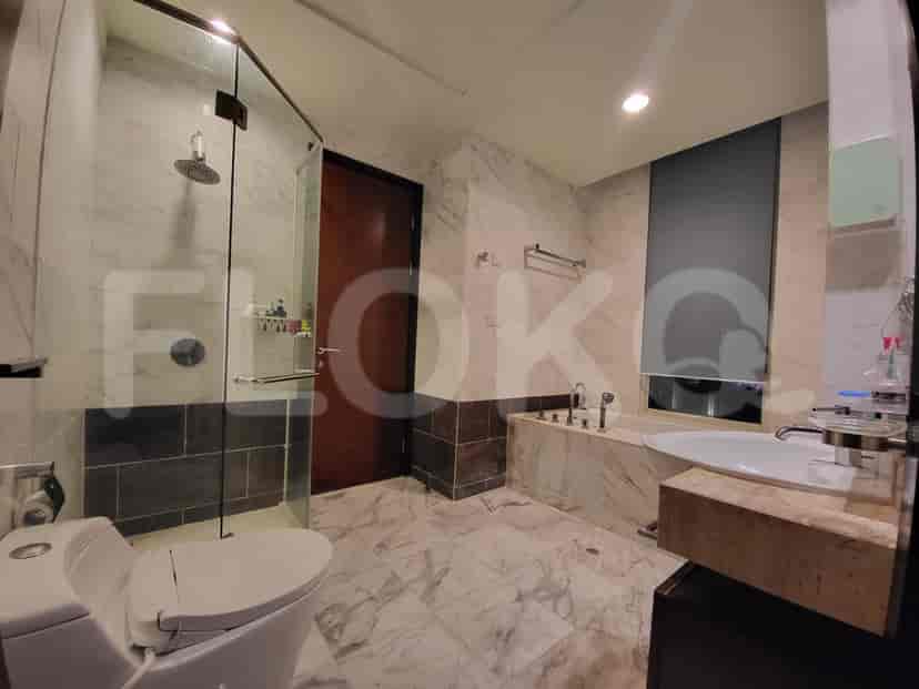 A luxurious bathroom with a bathtub, shower, and marble finishes.