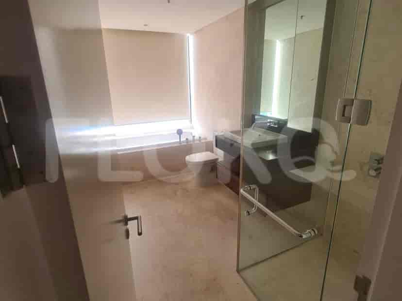 Modern bathroom with a large mirror, bathtub, and glass shower enclosure.