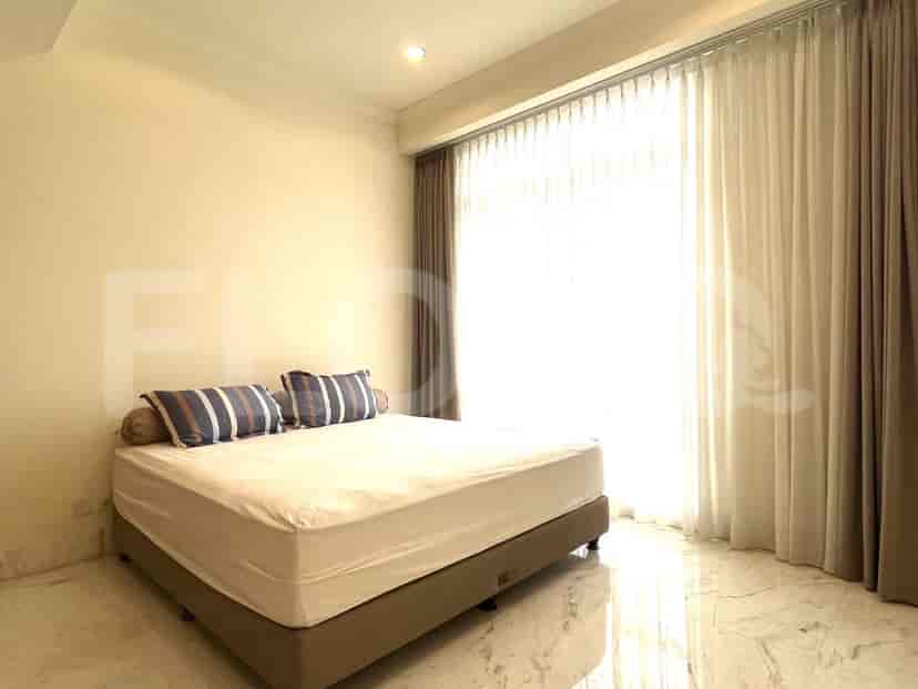 Bedroom with a bed and large window.
