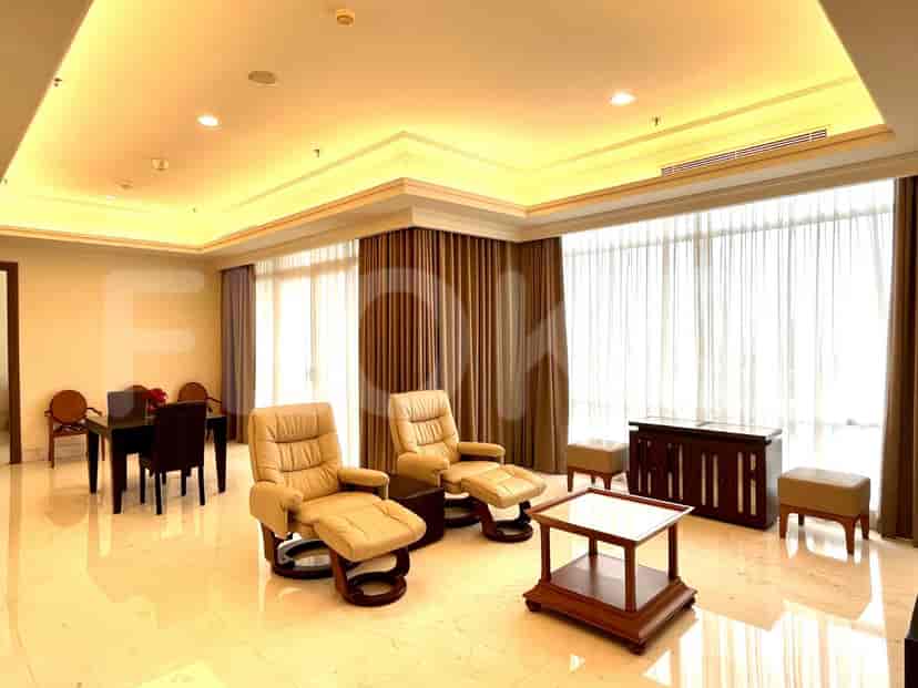 Living room showing seating, dining table and access to a bedroom.