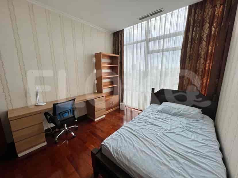 A bedroom with a desk, bed, and bookcase.