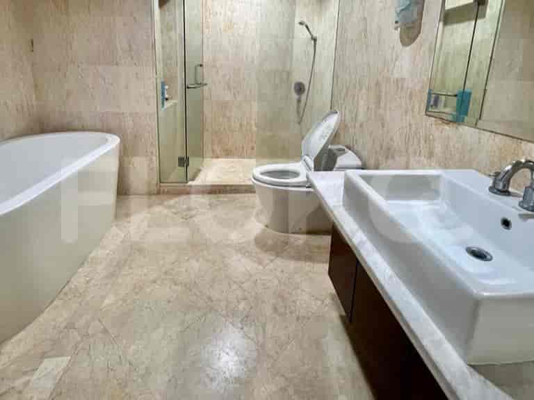 A bathroom with a bathtub, shower, and sink.