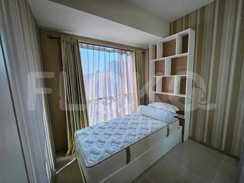 A cozy bedroom with a single bed and shelving.