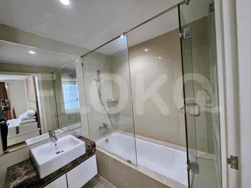 A contemporary bathroom with a bathtub and glass shower enclosure.