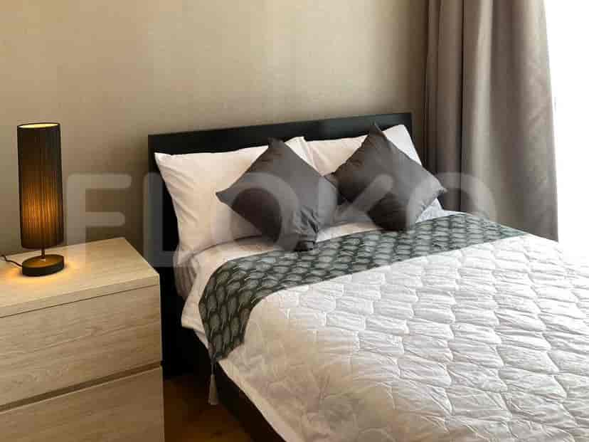 Bedroom with a bed, bedside table, and lamp.