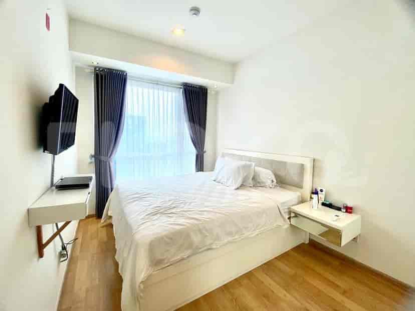 Bedroom with a double bed, side table, and curtains.