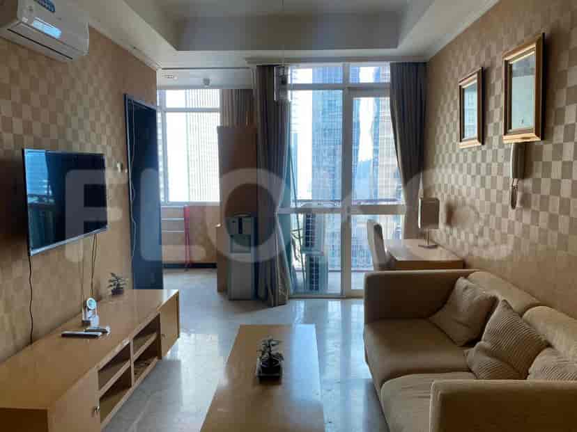 Living room with a TV, sofa, and a view.