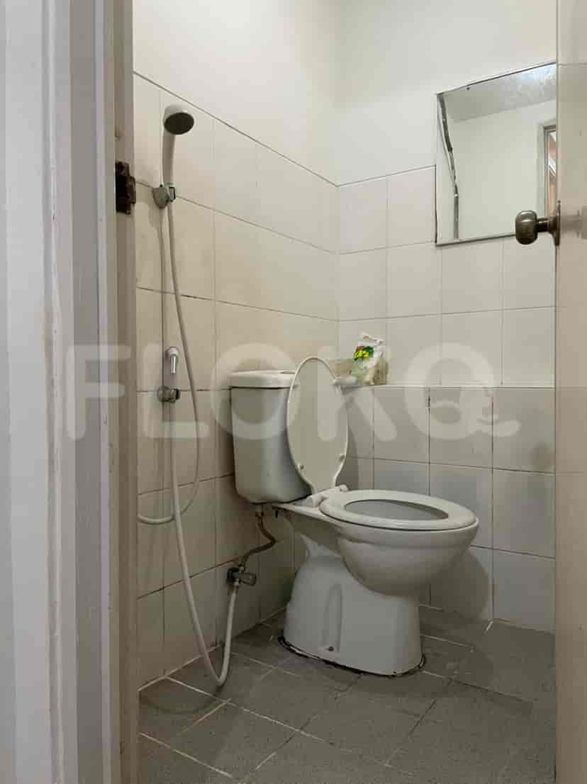 A bathroom with a toilet and shower.
