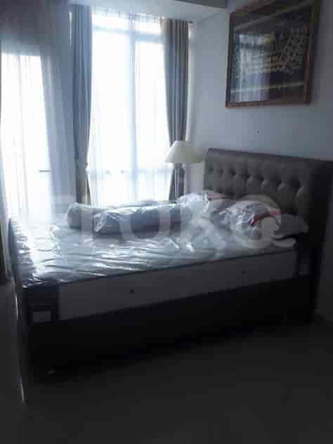 Bedroom with a bed, large window, and artwork.